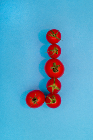 Red ripe tomatoes on a blue background, top viewの写真素材