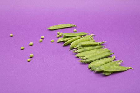Still life with buckets and green peas on a purple backgroundの写真素材