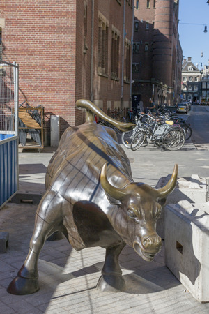 Amsterdam, Netherlands - July 02, 2018: Sculpture by Arturo Di Modica "Attacking bull" in the center of Amsterdam during the repair work on the squareのeditorial素材