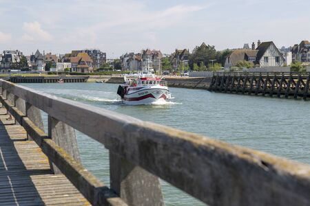 Trouville, France - July 05, 2018: A pleasure boat with tourists goes to seaのeditorial素材