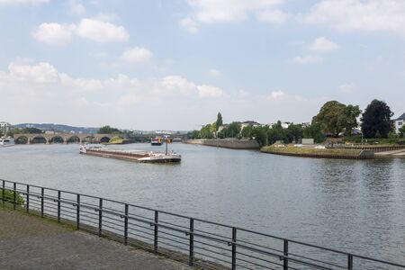 Koblenz, Germany - July 07, 2018: Carriage of goods by barges along the Moselle river in Koblenz