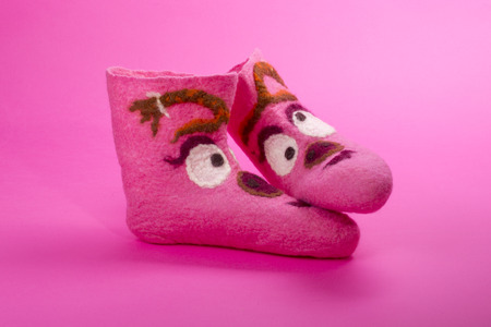Pink felt socks with a pattern on a pinkの写真素材