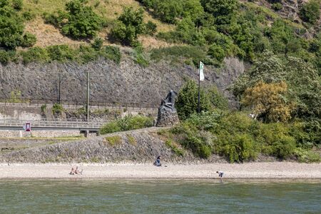 River Rhine, Germany - July 07, 2018: Bronze sculpture of a mermaid at the foot of the Loreley rock on the banks of the Rhine in Germanyのeditorial素材