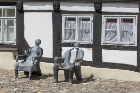 Goslar, Germany - July 08, 2018: Chairs-sculpture in the form of a man and a woman in the center of Goslar, Germanyのeditorial素材