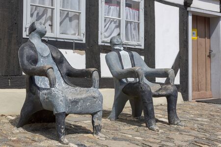 Goslar, Germany - July 08, 2018: Chairs-sculpture in the form of a man and a woman in the center of Goslar, Germanyのeditorial素材