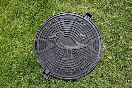 St. Petersburg, Russia - August 10, 2018: Manhole cover underground utilities in the park "New Holland" in St. Petersburgのeditorial素材