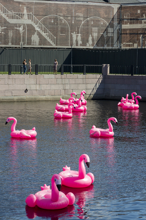 St. Petersburg, Russia - August 10, 2018: Pink inflatable swans swim on the pond in the territory of the city park "New Holland" in St. Petersburgのeditorial素材