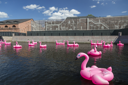 St. Petersburg, Russia - August 10, 2018: Pink inflatable swans swim on the pond in the territory of the city park "New Holland" in St. Petersburgのeditorial素材