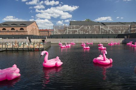 St. Petersburg, Russia - August 10, 2018: Pink inflatable swans swim on the pond in the territory of the city park "New Holland" in St. Petersburgのeditorial素材