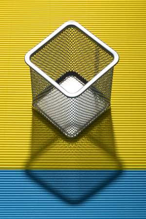 Abstract still life with a metal cup stand for pens and pencilsの写真素材