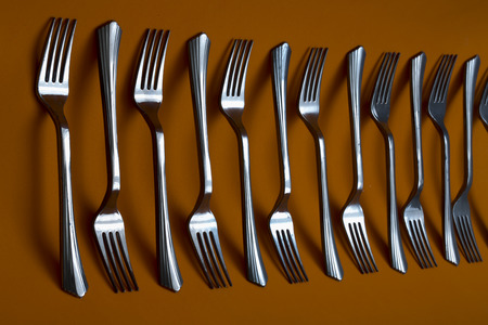Abstract still life with forks on brown backgroundの写真素材
