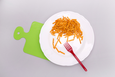 Potato straws on a white plate, top viewの写真素材