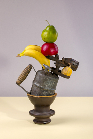 Abstract still life with pumpkins, blowtorch, bananas, cactus, tomato and pear.の写真素材