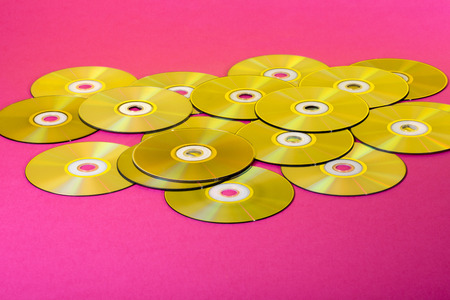 Laser Compact discs on a pink  with color reflectionの写真素材