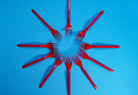 Figure of red forks on a blue background.の写真素材