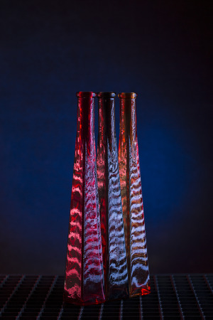 Still life with three glass bottles on a dark backgroundの写真素材