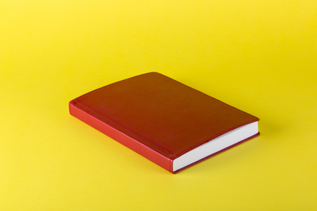 Red notepad on a yellow background, for decoration, for text design, for templateの写真素材