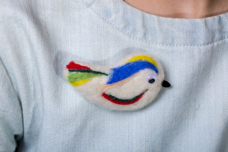 Felted wool brooch in the shape of a birdの写真素材