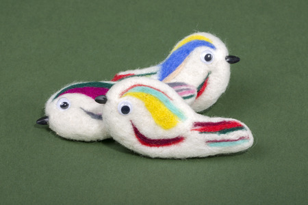 Three brooches of felted wool in the form of birdsの写真素材