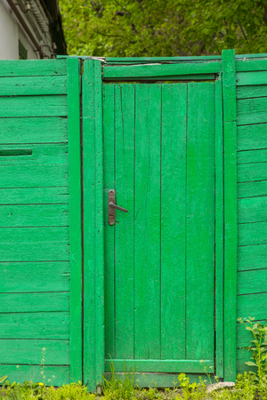 Old green entrance door from wooden planksの写真素材