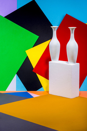 Still life with white vases on a color abstract background.の写真素材