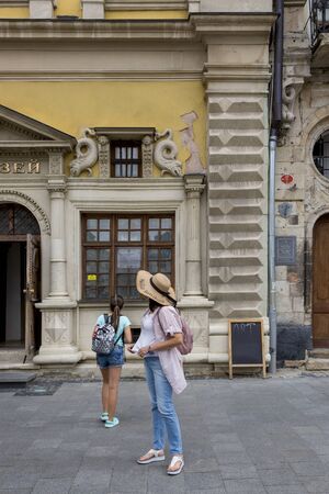 Lviv, Ukraine - August 13, 2019: Tourists explore the sights of Lvivのeditorial素材