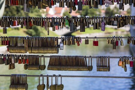 Ljubljana, Slovenia - August 15, 2019: Love padlocks on the fence of the bridge over the river in Ljubljanaのeditorial素材