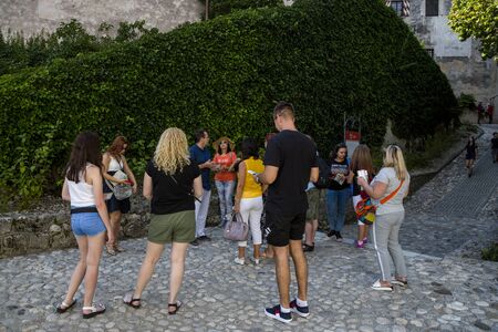 Bled, Slovenia - August 15, 2019: Tourists carefully listen to the guide on the territory of the old castle on the shore of Lake Bled in Slovenia.のeditorial素材