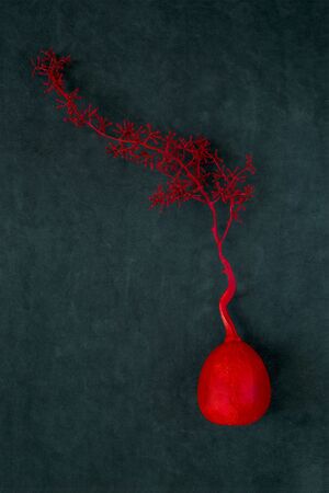 Still life with a painted decorative pumpkin and a branchの写真素材