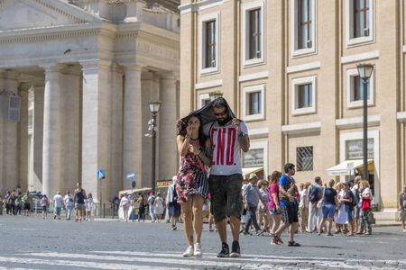 Rome, Italy - August 17, 2019: A guy and a girl under the scorching sun in St. Peter's Square in Rome. Happy endのeditorial素材