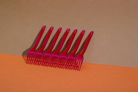 Abstract still life with red forks on a colored