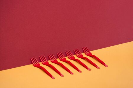 Abstract still life with red forks on a coloredの写真素材