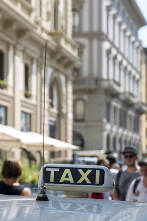 Checker taxi lighted rooftop car on a blurred backgroundの写真素材