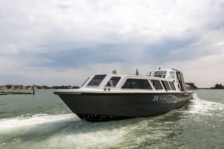 Venice, Italy - August 22, 2019: Passenger boat departs from the pier in Venice.のeditorial素材