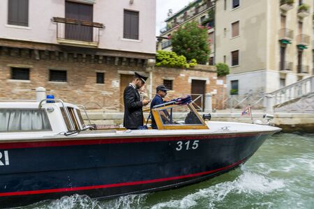 Venice, Italy - August 22, 2019: Water gendarmerie on a boat patrols canals of the city of Veniceのeditorial素材
