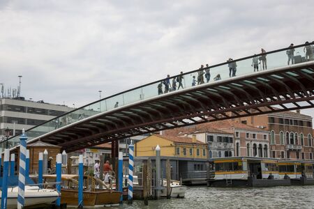 Venice, Italy - August 22, 2019: People on the glass Constitution Bridge over the Grand Canal in Veniceのeditorial素材