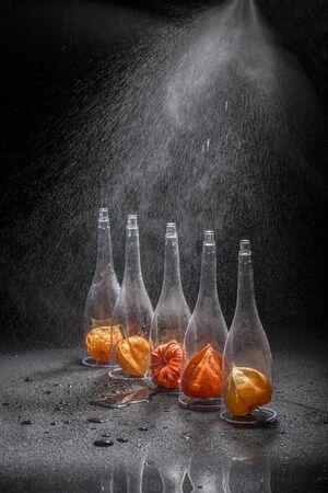 Still life with physalis fruits in transparent shapes under water drops.の写真素材