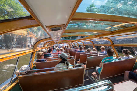 Amsterdam, Netherlands - July 02, 2018: Tourists inside the pleasure boat in Amsterdamのeditorial素材
