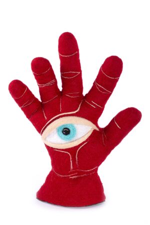 Protective amulet in the shape of an open palm and eye made of felted woolの写真素材
