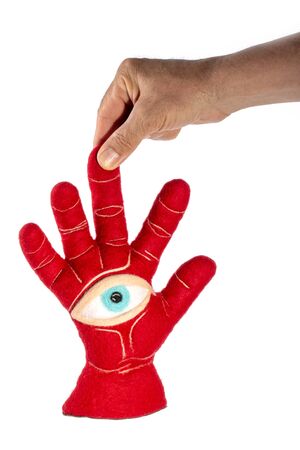 Protective amulet in the shape of an open palm and eye made of felted woolの写真素材