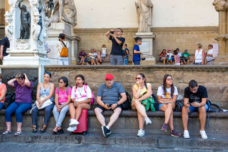 Florence, Italy - August 21, 2019: Tourists rest in Piazza della Signoria in Florenceのeditorial素材