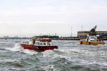 Venice, Italy - August 22, 2019: Passenger boats approaches the coast in Venice