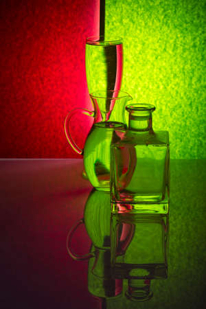 Still life with glass objects on a colored backgroundの写真素材