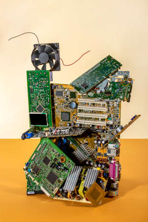 Abstract figure folded from computer circuit boards on a colored background