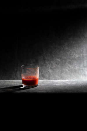 Glass cup with tomato juice on a dark backgroundの写真素材