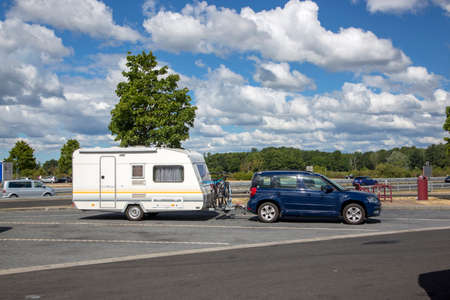 Berlin, Germany - July 01, 2018: Car with a trailer parked while traveling.のeditorial素材
