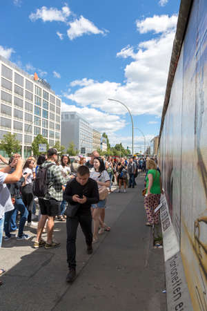 Berlin, Germany - July 01, 2018: People inspect the surviving fragment of the Berlin Wallのeditorial素材