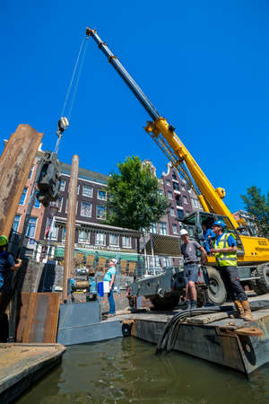 Amsterdam, Netherlands - July 02, 2018: Construction and installation works on the embankment of...