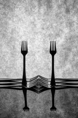 Very simple still life with forks on gray backgroundの写真素材