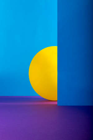 Abstract still life with sheets of colored paper and yellow ballの写真素材